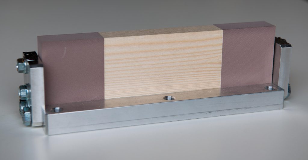 The sample holder with the wooden sample fixed between PUR blocks 